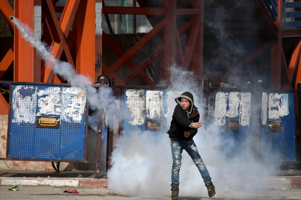 A protesters is seen as they clash with Israeli security forces during a protest against US decision to suspend financial aid earmarked for the UN Relief and Works Agency (UNRWA), at Jalazone refugee camp in Ramallah, West Bank on January 28, 2018. (Issam