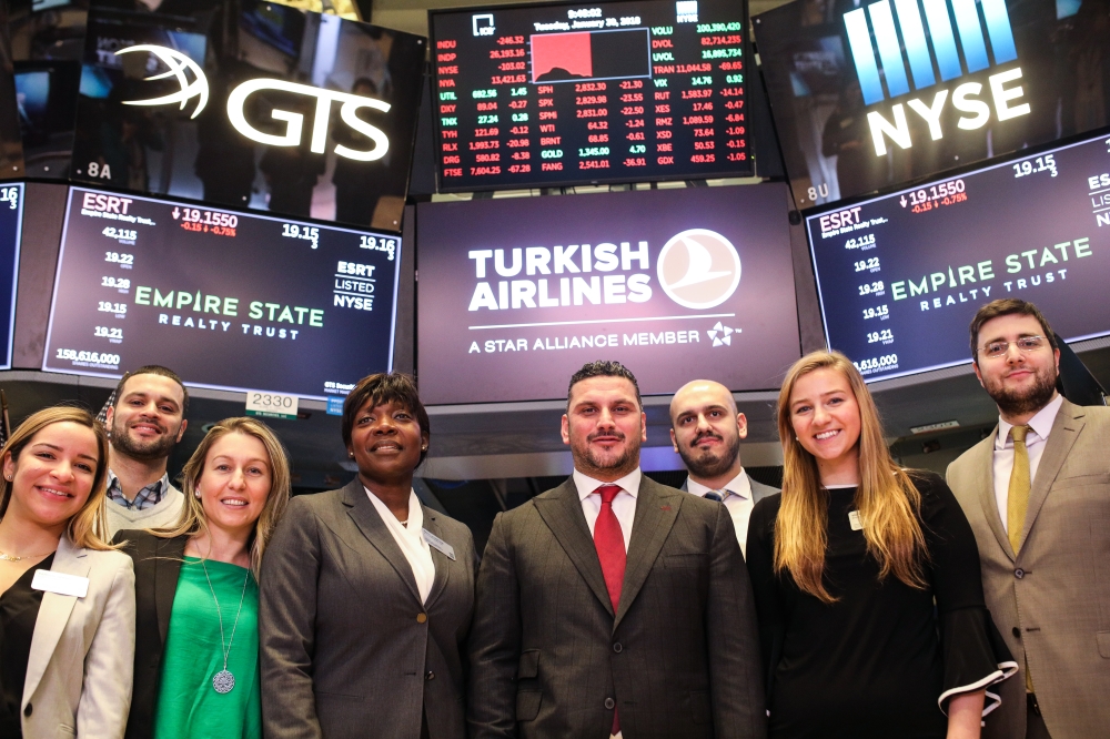 Cenk Ocal, General Manager of the Turkish Airlines, New York (front 3rd R) poses for a family photo with his team mates after Turkish Airlines rang the opening bell of New York Stock Exchange , in New York, United States on January 30, 2018. At?lgan Özdil