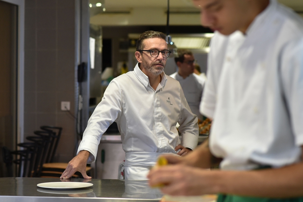 (FILES) This file photo taken on September 21, 2017, shows French chef Sebastien Bras posing in the kitchen of his three-star restaurant Le Suquet, in Laguiole, southern France, after announcing that he asked not to be included in the Michelin Guide start