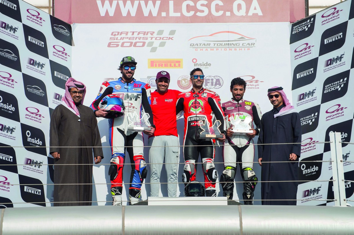 The podium winners of the Qatar Superstock600 Championship (QSTK) are seen with officials of Qatar Motor and Motorcycle Federation at Losail International Circuit.