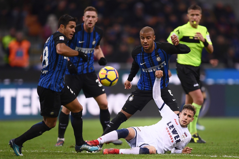 Inter Milan's forward Rafinha Alcantara of Brazil (C) fights for the ball with Crotone's forward Adrian Stoian from Romania (R) during the Italian Serie A football match Inter Milan Vs Crotone on February 3, 2018 at 'Giuseppe Meazza' stadium in Milan. / A