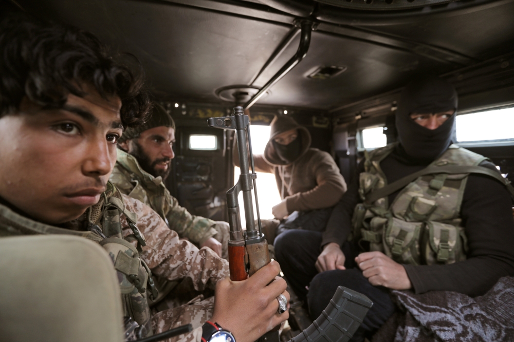 Turkey-backed Free Syrian Army fighters are seen in their vehicle in al Ajami village in east al Bab, Syria February 3,2018.REUTERS/ Khalil Ashawi