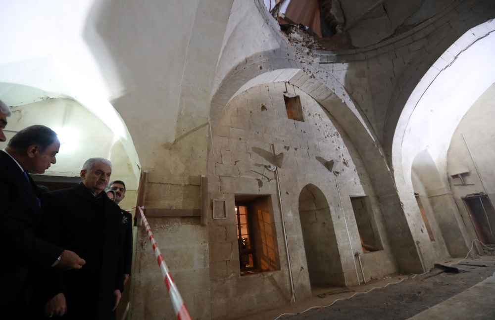 Prime Minister of Turkey, Binali Yildirim (2 L) inspects the Calik Mosque after a rocket fired by PYD/PKK terrorists from Syria hit the three centuries old Mosque in the Turkish border province of Kilis, Turkey on February 04, 2018 in Kilis, Turkey.  Haka