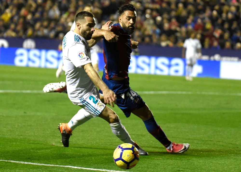 Real Madrid's defender Dani Carvajal (L) vies with Levante's forward Ivan Lopez 