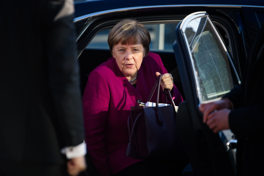 German Chancellor Angela Merkel, leader of the conservative Christian Democratic Union (CDU), gets off her car as she arrives for further talks to form a new government in Berlin on February 6, 2018. AFP / Gregor Fischer