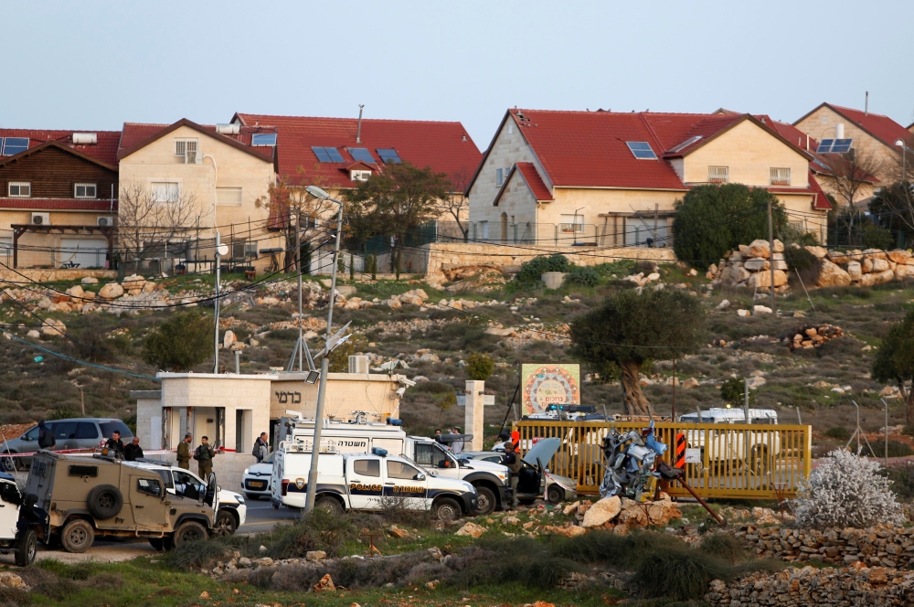Israeli troops gather at the scene of a stabbing attack north of Hebron, in the occupied West Bank, February 7, 2018. REUTERS/Mussa Qawasma 