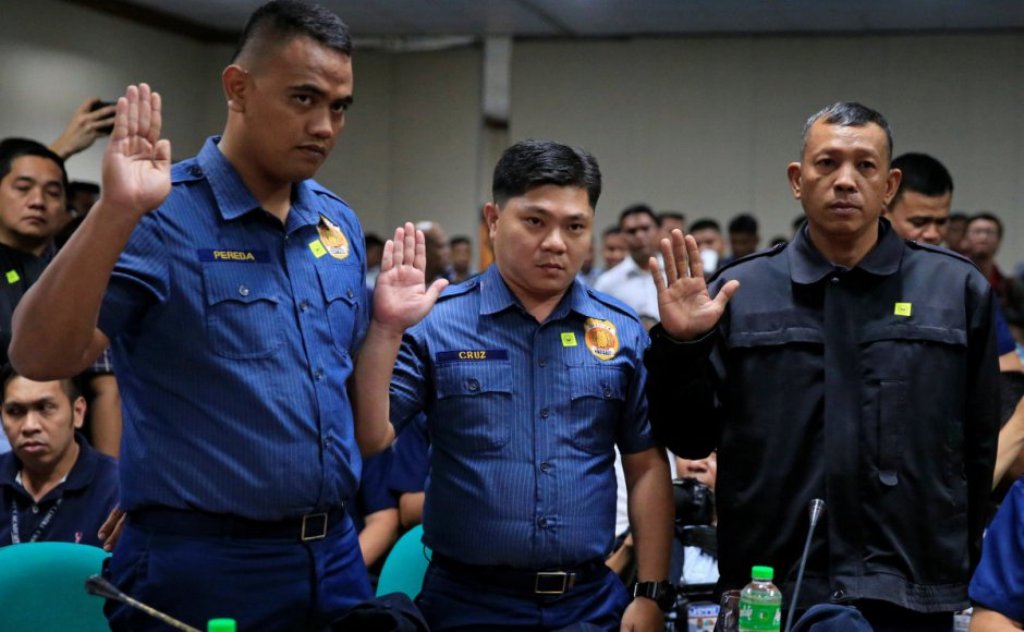 File photo of Philippines National Police (PNP) officers Jeremias Pereda, Jerwin Cruz and Arnel Oares take an oath during a hearing on the killing of 17-year-old high school student Kian Delos Santos in a police raid, at the Senate headquarters in Pasay c