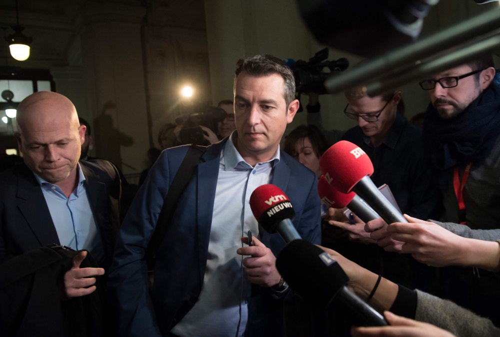 Belgian lawyer representing Paris attacks suspect Salah Abdeslam Sven Mary (L) and Belgian lawyer representing the civilian party and police officers Tom Bauwens (C) walk past journalists as they leave the 