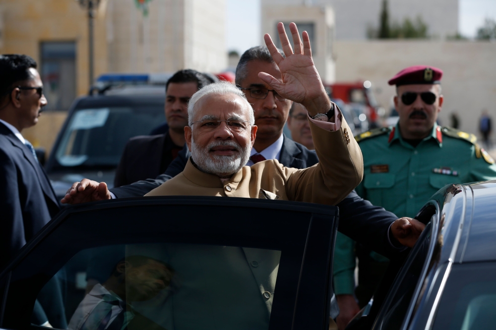 Indian Prime Minister Narendra Modi waves upon his arrival for a meeting with Palestinian president Mahmud Abbas in the West Bank city of Ramallah on February 10, 2018. / AFP / ABBAS MOMANI
