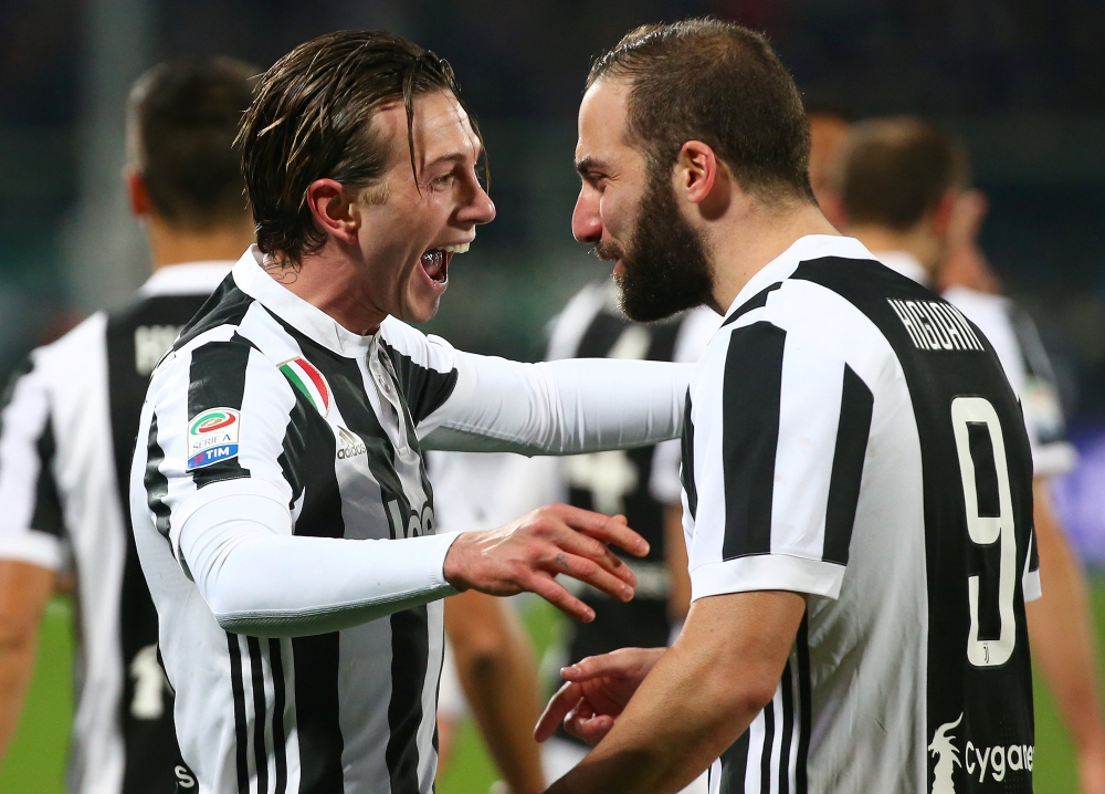 Juventus’ Federico Bernardeschi celebrates with Gonzalo Higuain after scoring their first goal REUTERS/Alessandro Bianchi
