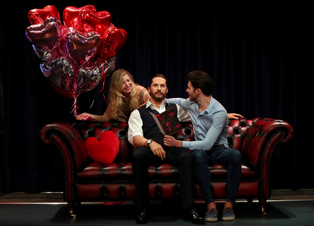 People pose next to Madame Tussauds' wax figure of British actor Tom Hardy which has a soft warm chest and a beating heart, in London, Britain, February 8, 2018. Reuters/Hannah McKay