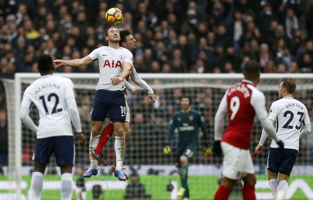 Tottenham Hotspur's English striker Harry Kane (2L) leaps for the ball against Arsenal's French defender Laurent Koscielny (3L) during the English Premier League football match between Tottenham Hotspur and Arsenal at Wembley Stadium in London, on Februar