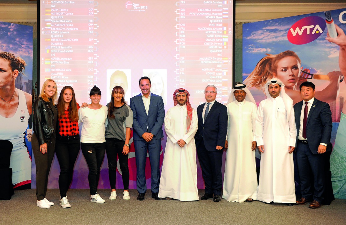 (From left) Russia’s Elena Vesnina, Daria Kasatkina, Tunisian player Ons Jabeur, Oman’s Fatima Al Nabhani  pose for a photograph with Qatar Tennis Federation and Qatar Total officials following the Qatar Total Open 2018 official draw ceremony held in Doha