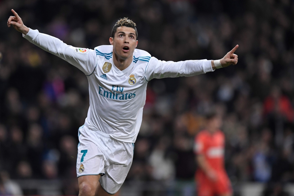Real Madrid's Portuguese forward Cristiano Ronaldo celebrates after scoring during the Spanish league football match between Real Madrid CF and Real Sociedad at the Santiago Bernabeu stadium in Madrid on February 10, 2018. / AFP / GABRIEL BOUYS
