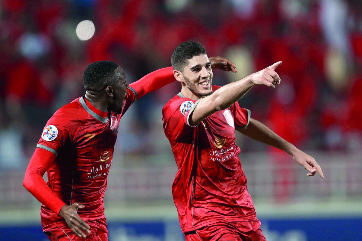 Al Duhail’s Karim Boudiaf (right) celebrates with a team-mate after scoring against Iranian Zobahan during their AFC Champions League match played at the Abdullah bin Khalifa Stadium in Doha yesterday.