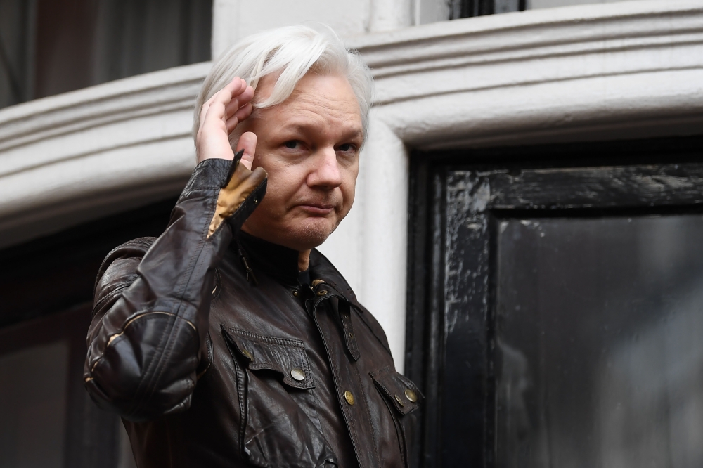 In this file photo taken on May 19, 2017 Wikileaks founder Julian Assange appears on the balcony after making an address to the media at the Embassy of Ecuador in London.  AFP / Justin Tallis
