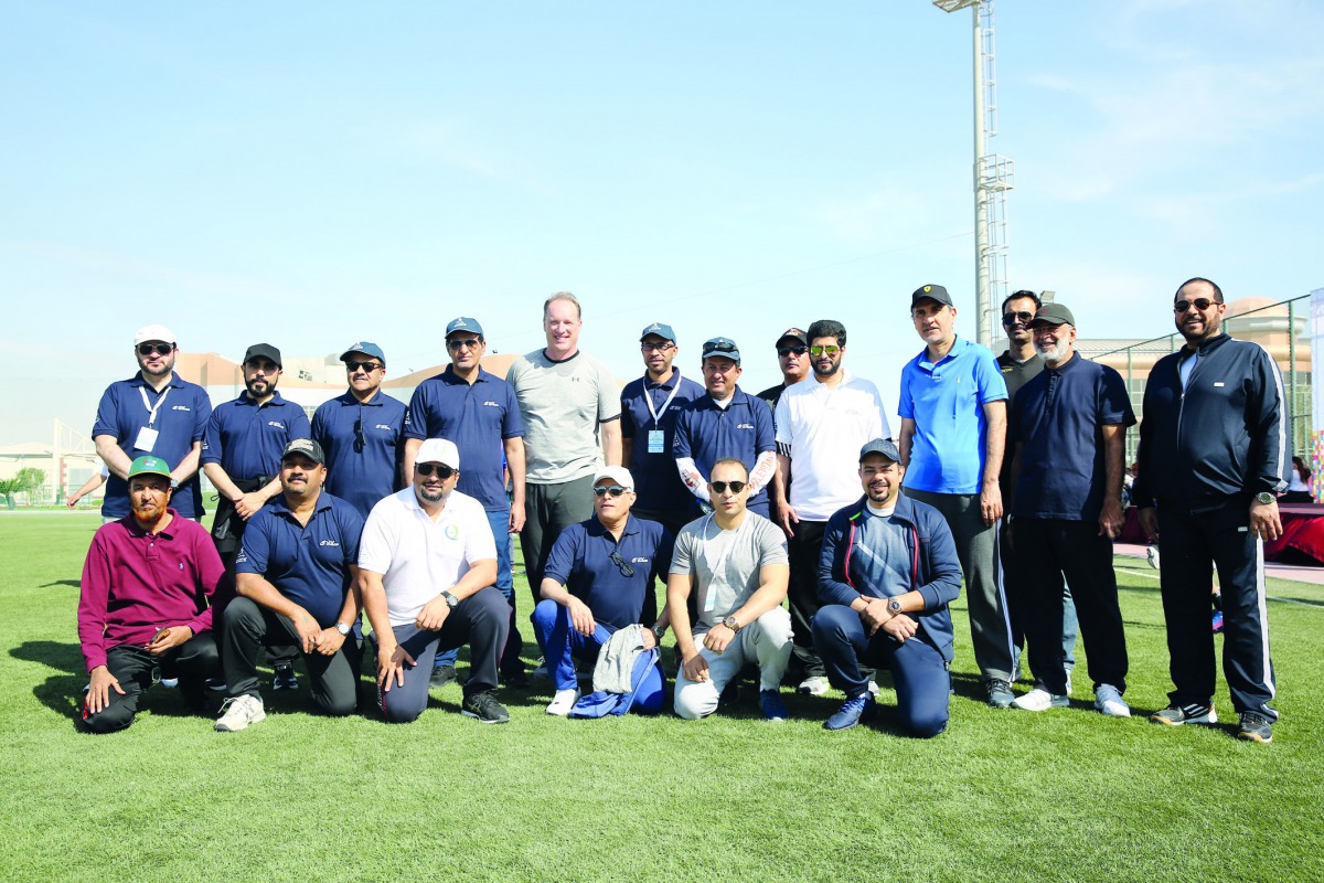 Q-Chem officials posing for a photo on the sidelines of National Sport Day activities, yesterday.