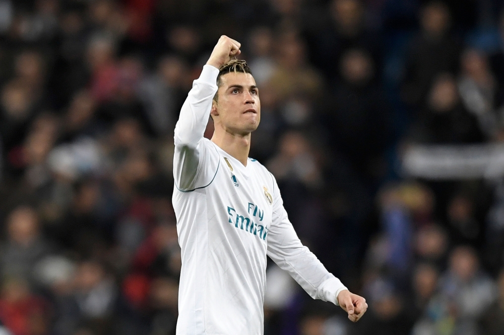 Real Madrid's Portuguese forward Cristiano Ronaldo celebrates at the end of the UEFA Champions League round of sixteen first leg football match Real Madrid CF against Paris Saint-Germain (PSG) at the Santiago Bernabeu stadium in Madrid on February 14, 201
