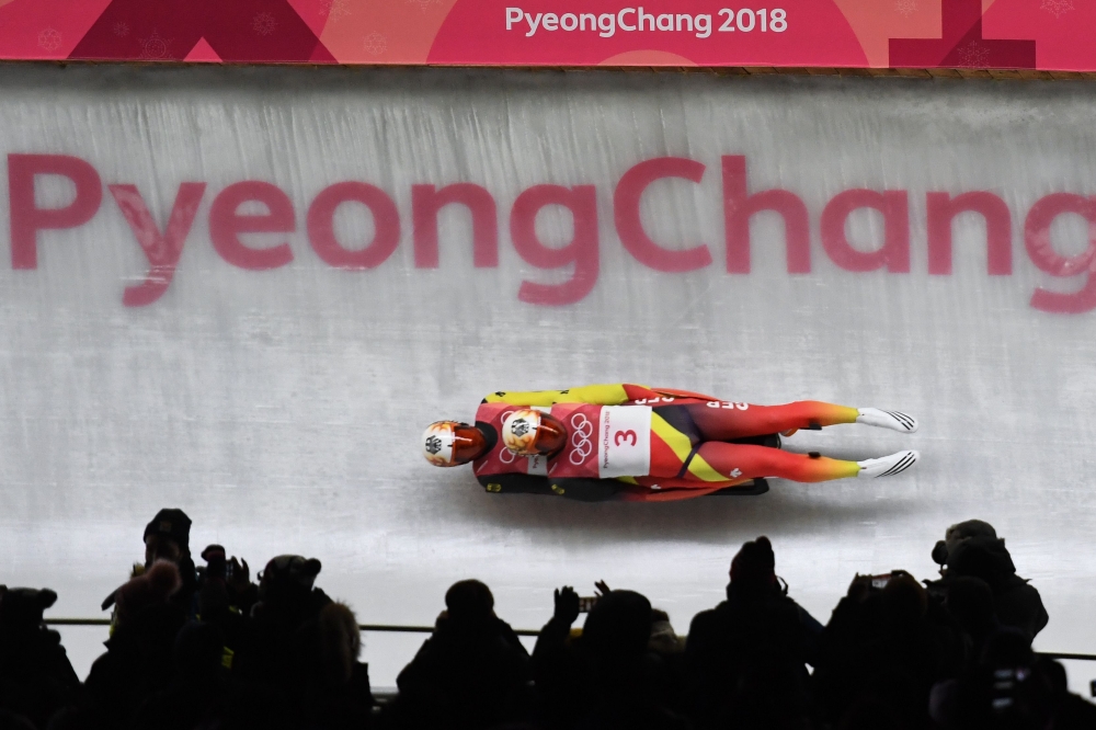 Germany's Tobias Wendl and Tobias Arlt compete in the doubles luge run 1 during the Pyeongchang 2018 Winter Olympic Games at the Olympic Sliding Centre on February 14, 2018 in Pyeongchang. / AFP / Mark RALSTON 