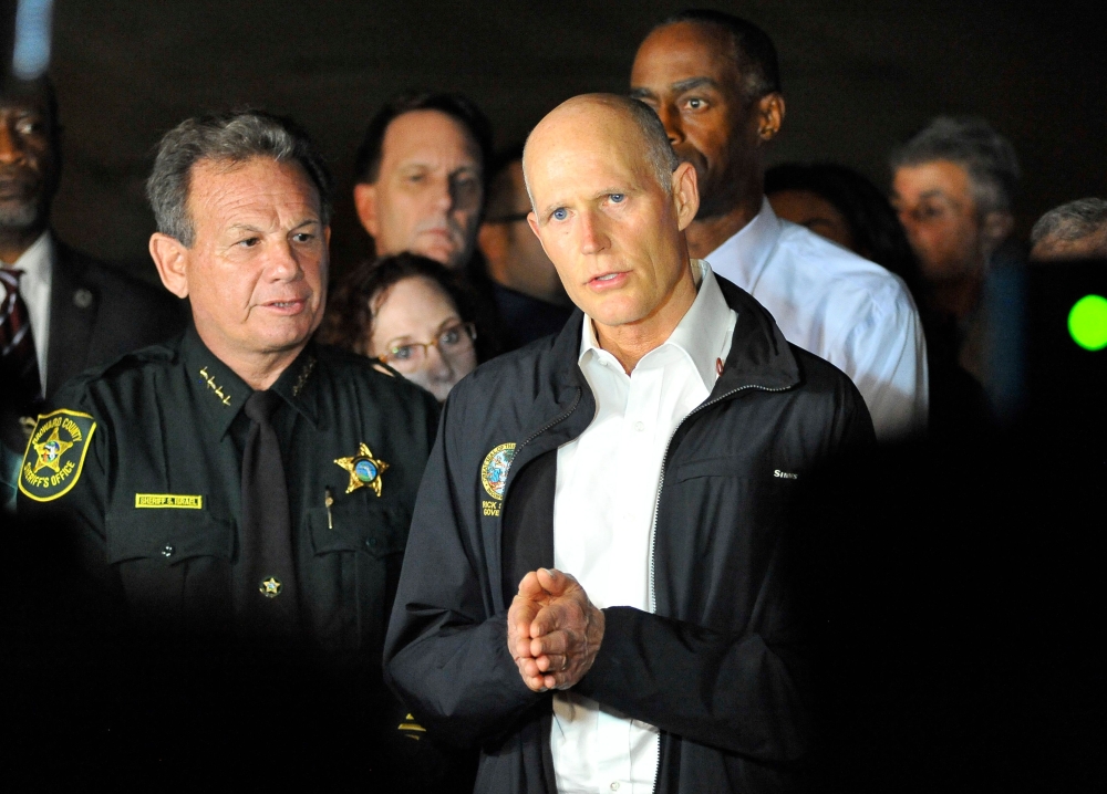 Florida Governor Rick Scott speaks to the media as he visits Marjory Stoneman Douglas High School following a shooting that killed 17 people on February 14, 2018 in Parkland, Florida. AFP / Gaston De Cardenas