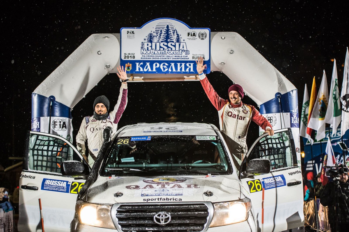 Qatar’s Adel Abdulla and navigator Nasser Al Kuwari wave to the crowd during the opening round of the 2018 FIA World Cup for Cross-Country Rallies in Karelia, Russia, yesterday.