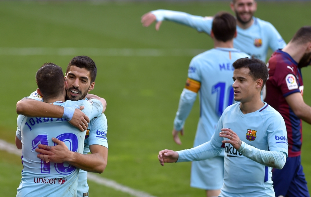Barcelona's Uruguayan forward Luis Suarez (2L) congratulates Barcelona's Spanish defender Jordi Alba (L) for his goal while Barcelona's Brazilian midfielder Philippe Coutinho (R) approaches during the Spanish league football match between SD Eibar and FC 