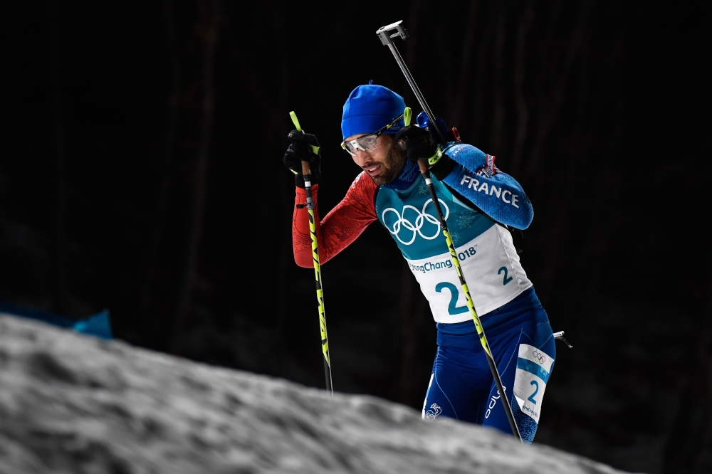 France's Martin Fourcade competes to win gold in the men's 15km mass start biathlon event during the Pyeongchang 2018 Winter Olympic Games on February 18, 2018, in Pyeongchang. / AFP / Jonathan NACKSTRAND
