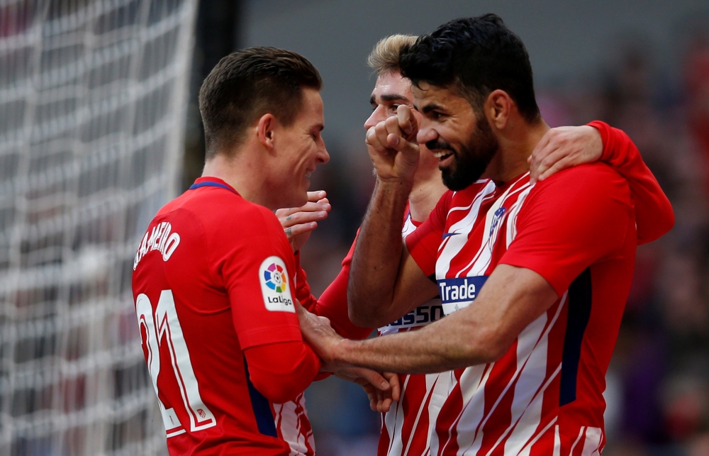 Atletico Madrid's Diego Costa celebrates scoring their second goal with Antoine Griezmann and Kevin Gameiro REUTERS/Javier Barbancho
