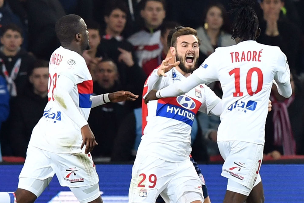 Lyon's Burkinabe forward Bertrand Traore (R) celebrates with teammates after scoring a goal during the French L1 football match between Lille OSC (LOSC) and Lyon at the Pierre-Mauroy Stadium in Villeneuve d'Ascq, near Lille, northern France, on February 1