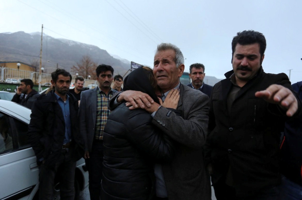 Relatives of a passenger who was believed to have been killed in a plane crash react near the town of Semirom, Iran, February 18, 2017. REUTERS/Tasnim News Agency 