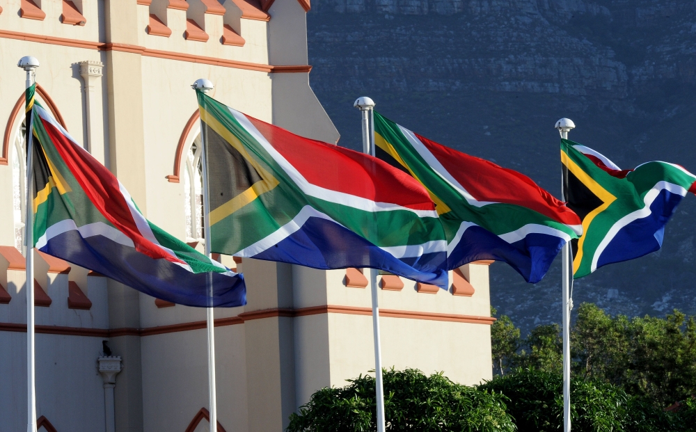 South African flags are seen during a ceremony ahead of South Africa's newly-minted president National address at the Parliament in Cape Town, on February 16, 2018.  AFP / Nasief Manie
