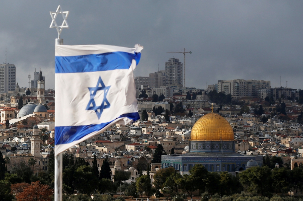 An Israeli flag is seen near the Dome of the Rock, located in Jerusalem's Old City on the compound known to Muslims as Noble Sanctuary, December 6, 2017. Reuters/Ammar Awad