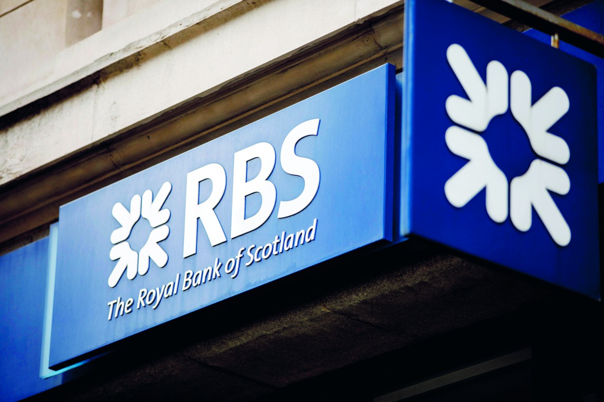In this file photo taken on October 22, 2017 signage is seen at the front of a branch of the Royal Bank of Scotland in central London. AFP / Tolga Akmen