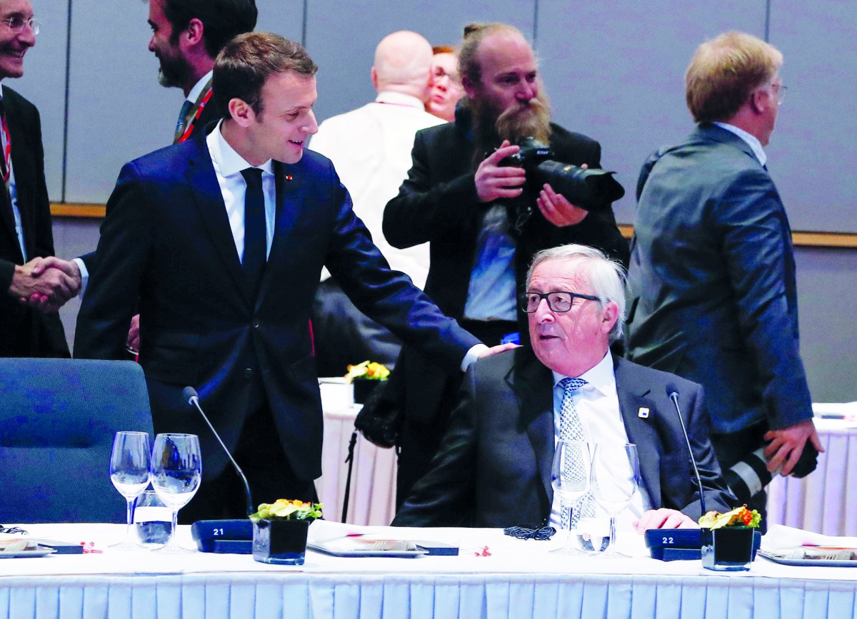 French President Emmanuel Macron talks with European Commission President Jean-Claude Juncker during a European Union leaders informal summit in Brussels, Belgium, February 23, 2018. Reuters/Yves Herman