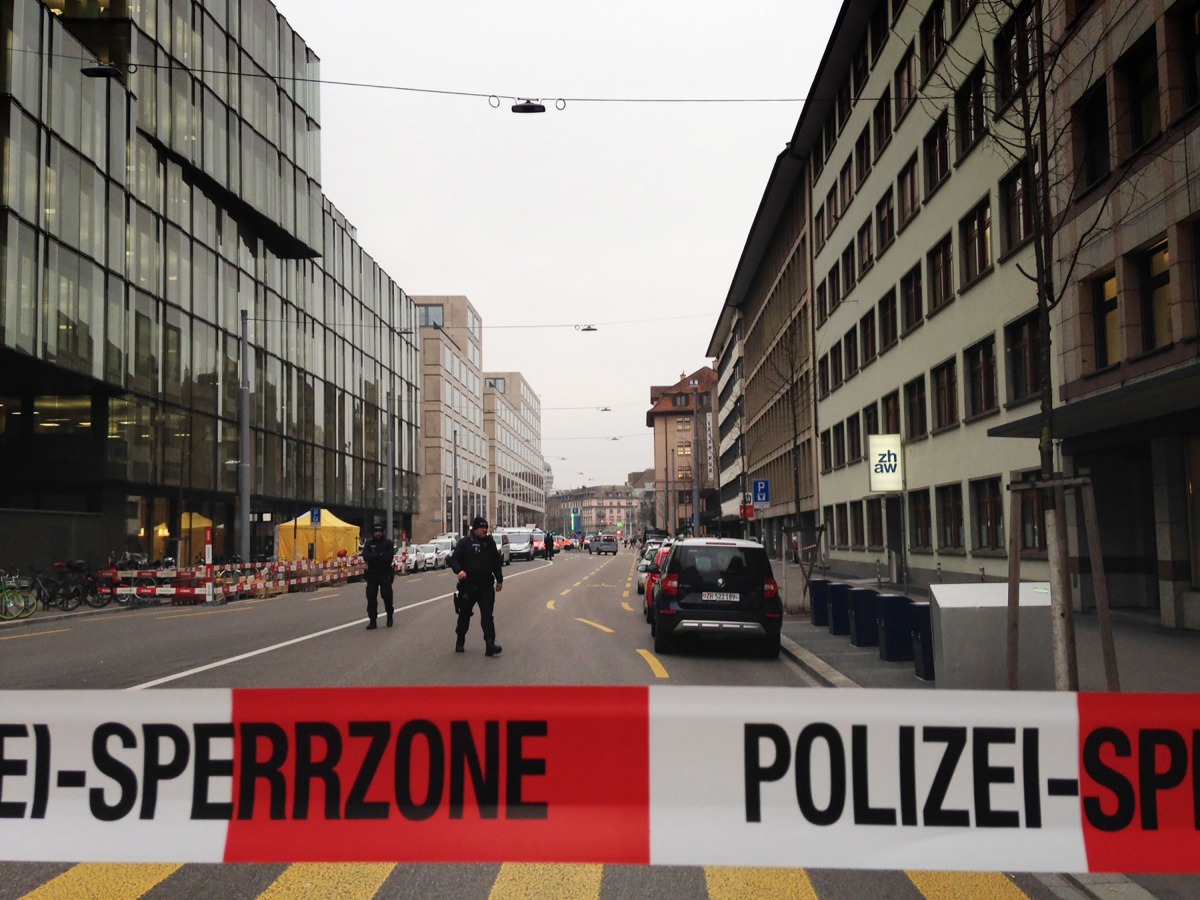 Police officials gather at the scene of a shooting outside a branch of UBS bank in Zurich on February 23, 2018. Two people were shot dead in central Zurich, police said, as media reported numerous shots had been fired in what appeared to have been a priva