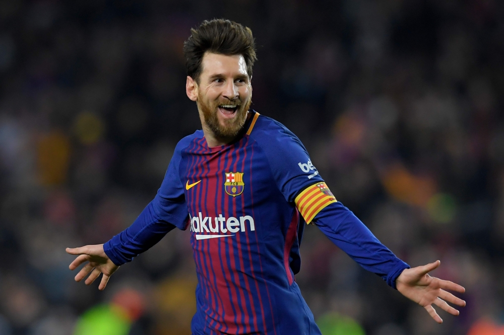 Barcelona's Argentinian forward Lionel Messi celebrates after scoring his second goal during the Spanish league football match between FC Barcelona and Girona FC at the Camp Nou stadium in Barcelona on February 24, 2018. / AFP / LLUIS GENE
