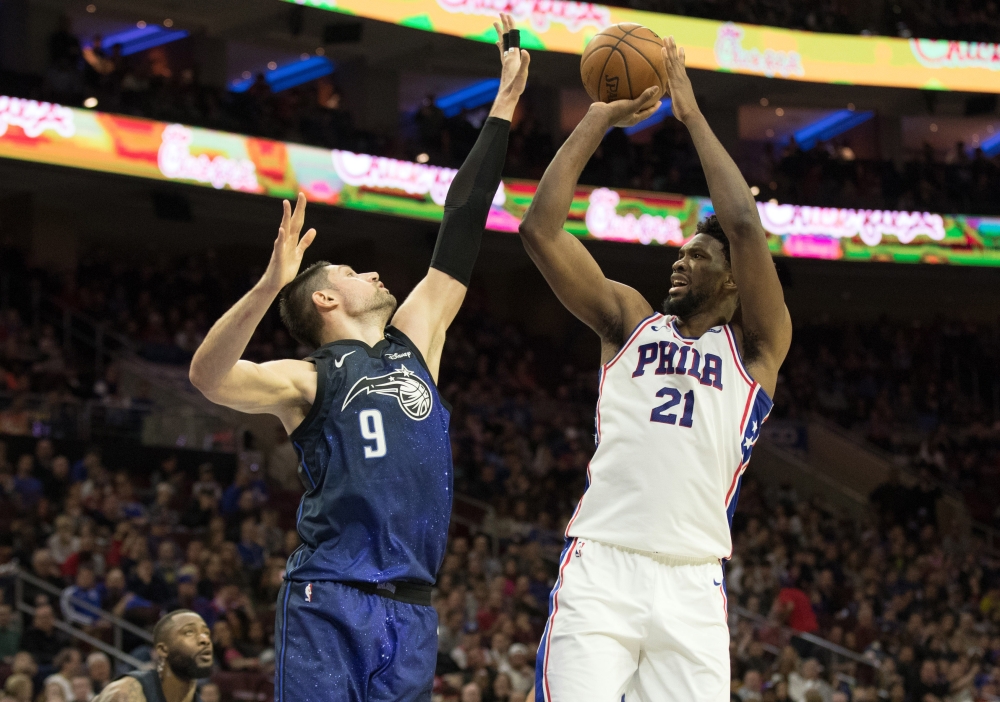 Philadelphia 76ers center Joel Embiid (21) shoots against Orlando Magic center Nikola Vucevic (9) during the second quarter at Wells Fargo Center.  Bill Streicher
