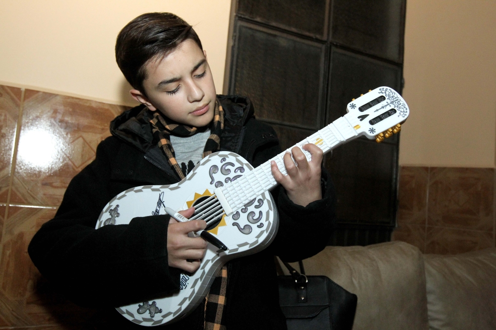 (FILES) In this file photo taken on January 24, 2018 Mexican singer Luis Angel Jaramillo, 13, rehearses with his guitar before a concert during the Villa Hidalgo Fair in Jalisco state, Mexico. AFP / ULISES RUIZ