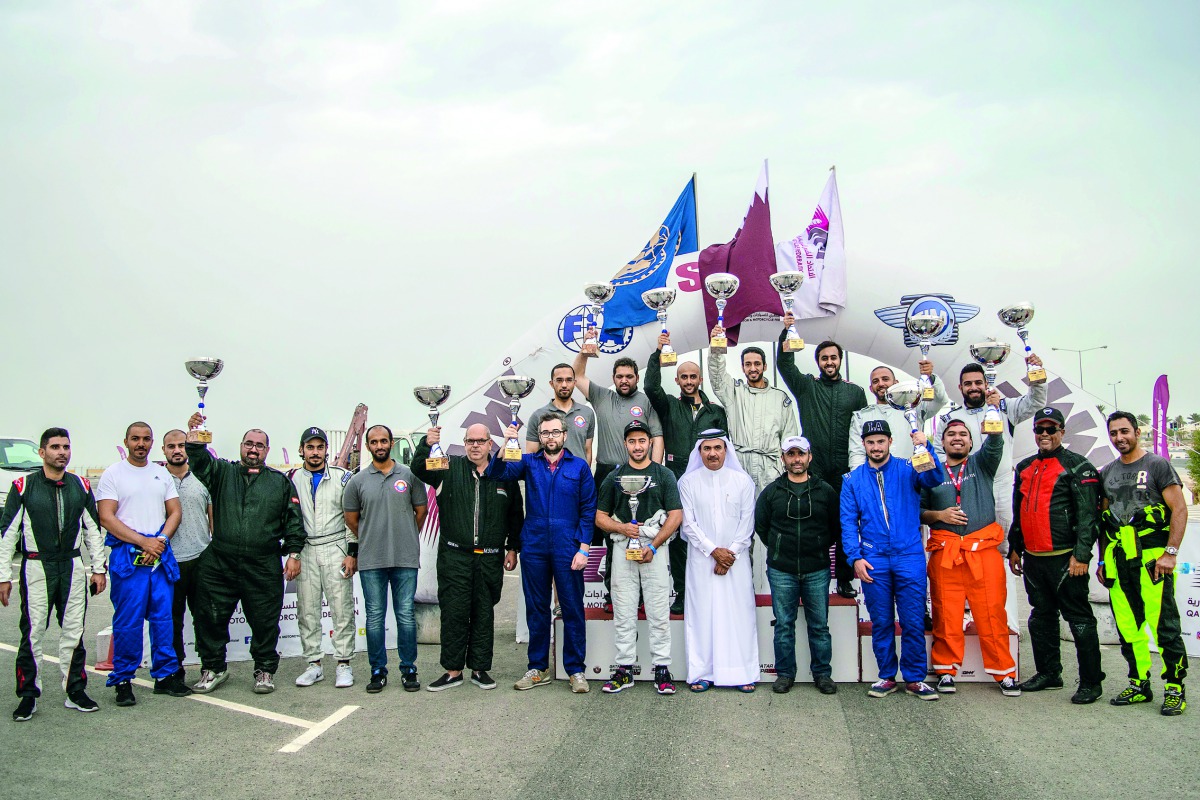 The podium winners and participants pose for a photograph with QMMF officials following the presentation ceremony of the Qatar National Sprint - Round 2 at the Losail Car Park on Saturday.