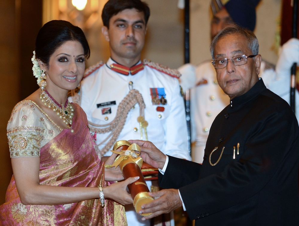 This file photo taken on April 5, 2013 shows then-Indian President Pranab Mukherjee (R) presenting the Padma Shree award to Indian film actress Sridevi (L) during the presentation of the 
