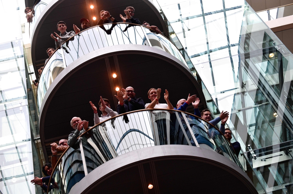 Members of Germany's Social Democrats (SPD) party applaud during a press conference as the result is announced of the SPD party members' referendum on whether or not to join a new coalition government with German Chancellor Angela Merkel's conservatives, 