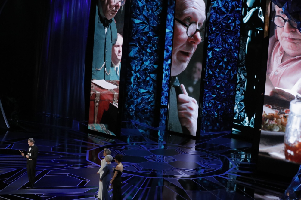 Gary Oldman (L) accepts the Oscar for Best Actor for 