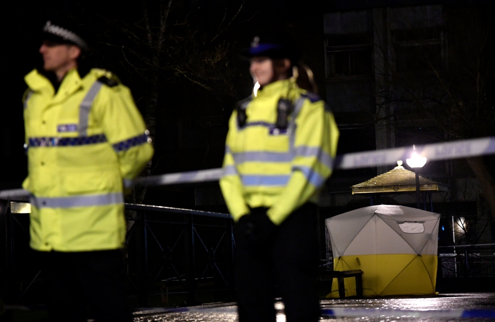 Police officers stand guard beside a cordoned-off area, after former Russian military intelligence officer Sergei Skripal, who was convicted in 2006 of spying for Britain, became critically ill after exposure to an unidentified substance, in Salisbury, so
