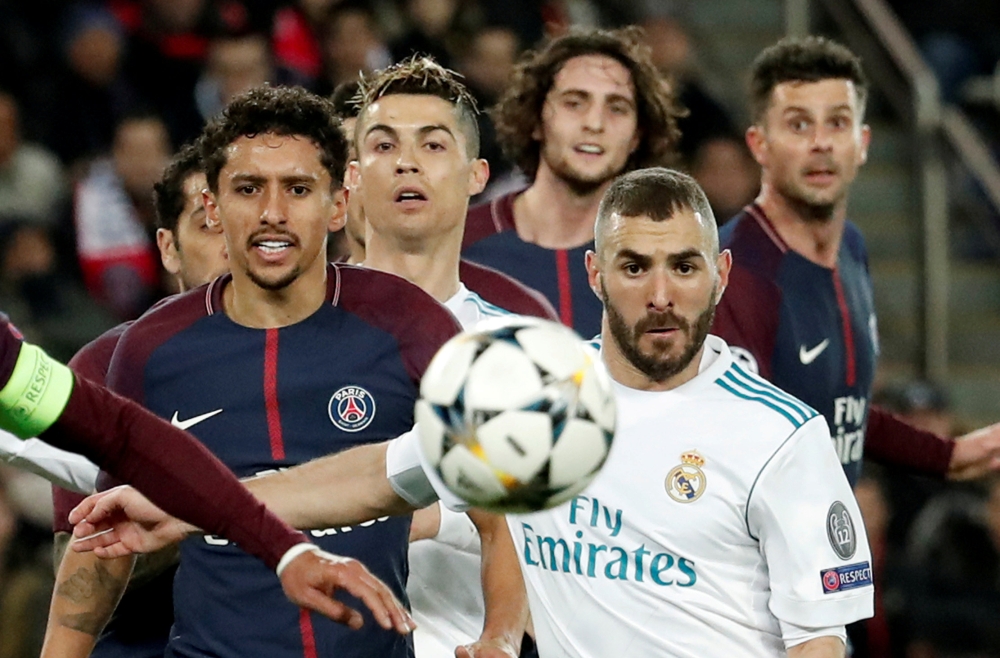 Paris Saint-Germain’s Marquinhos in action with Real Madrid’s Karim Benzema, March 6, 2018. REUTERS/Benoit Tessier 