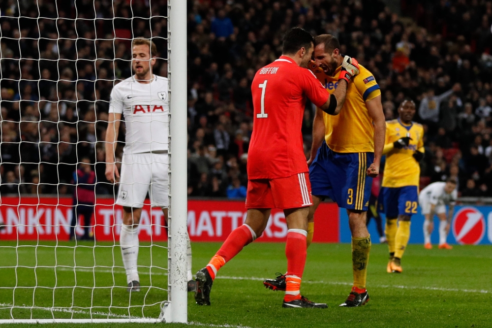Juventus' Italian defender Giorgio Chiellini (R) reacts with Juventus' Italian goalkeeper Gianluigi Buffon (L) after making an interception during the UEFA Champions League round of sixteen second leg football match between Tottenham Hotspur and Juventus 