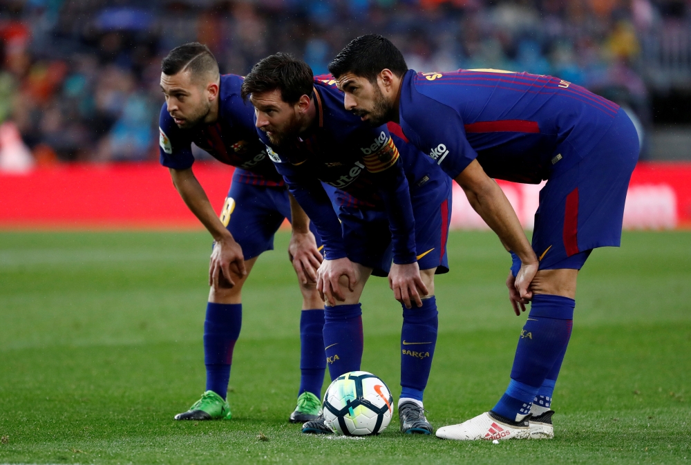 March 4, 2018 (L - R) Barcelona’s Jordi Alba, Lionel Messi and Luis Suarez prepare to take a free kick REUTERS/Juan Medina
