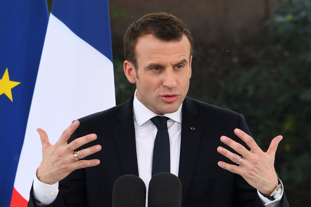 French President Emmanuel Macron gestures as he delivers a speech during a meeting with the French community resident in India at the French embassy in New Delhi on March 11, 2018.   AFP / DOMINIQUE FAGET
