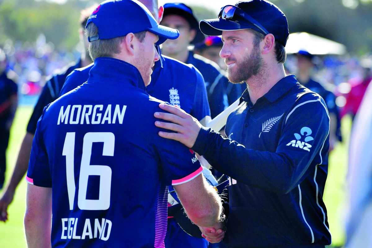 New Zealand's captain Kane Williamson (R) congratulates England's captain Eoin Morgan on their win following the fifth and final ODI cricket match between New Zealand and England at Hagley Oval in Christchurch on March 10, 2018. AFP / Marty Melville