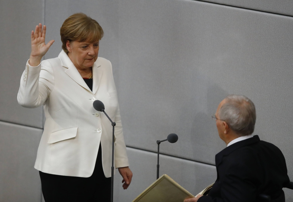 German Chancellor Angela Merkel is sworn-in by Parliament President Wolfgang Schaeuble during a meeting of Germany's lower house of parliament Bundestag in Berlin, Germany, March 14, 2018. REUTERS/Kai Pfaffenbach
