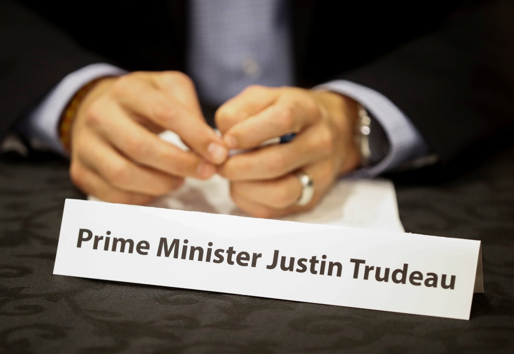 Canada's Prime Minister Justin Trudeau sits behind his name card at a round table discussion with steel industry leaders in Hamilton, Ontario, Canada, March 13, 2018. REUTERS/Mark Blinch